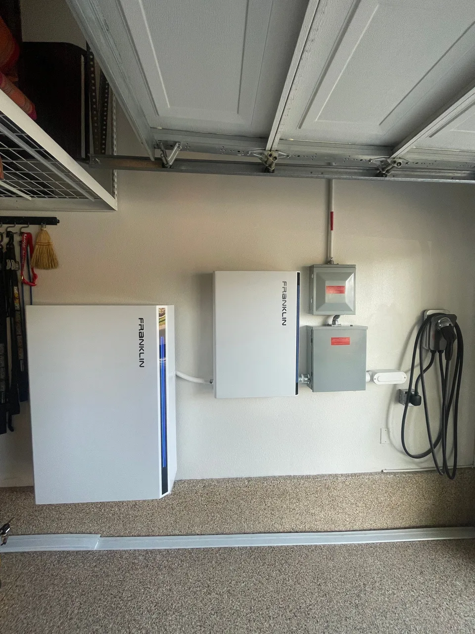A Franklin battery and control unit installed beside electrical panels in a garage.