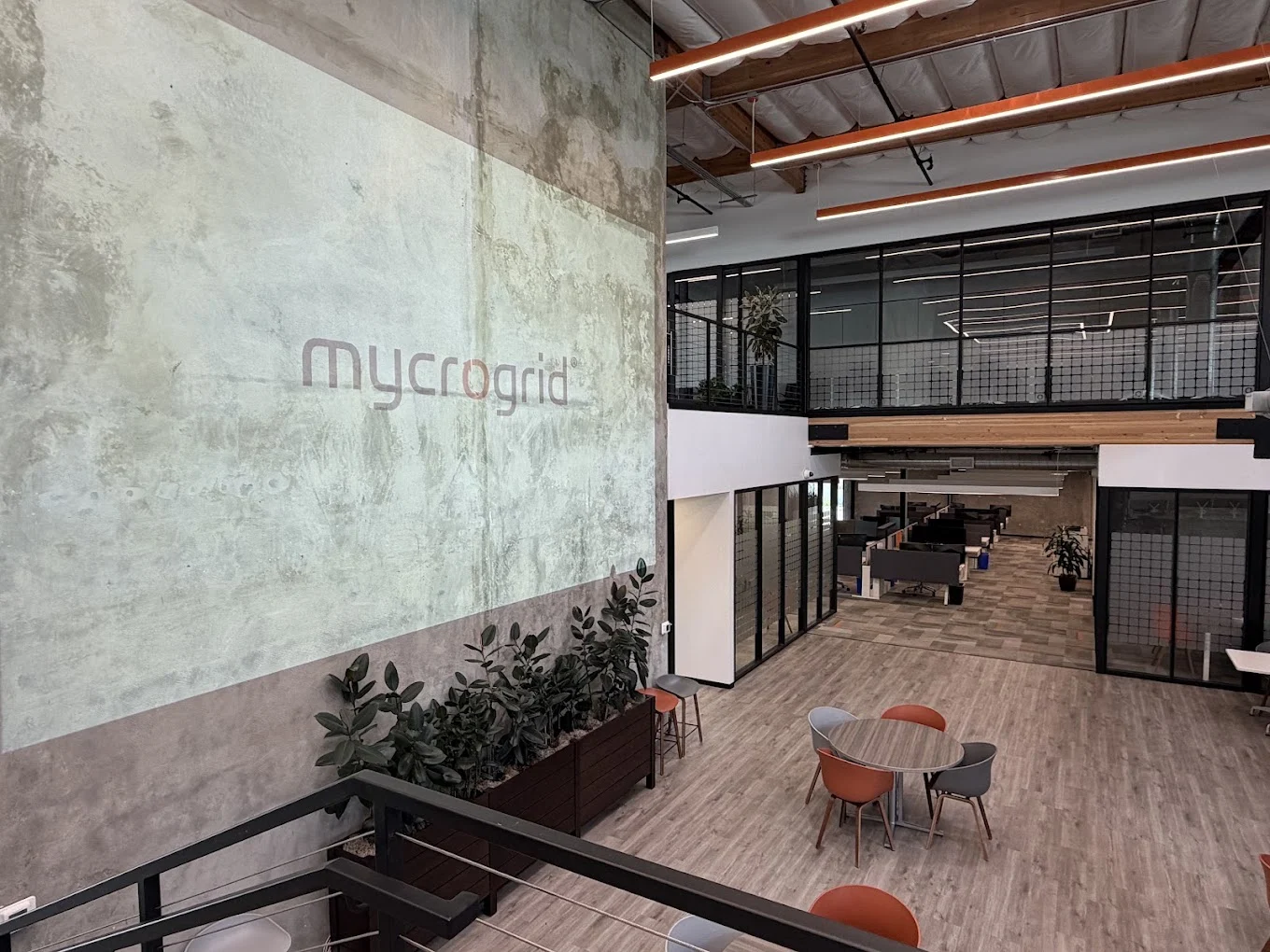 Mycrogrid® office atrium with the company logo projected across a concrete wall